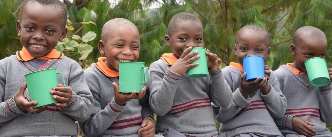 Boys drinking at a Ugandan Compassion project