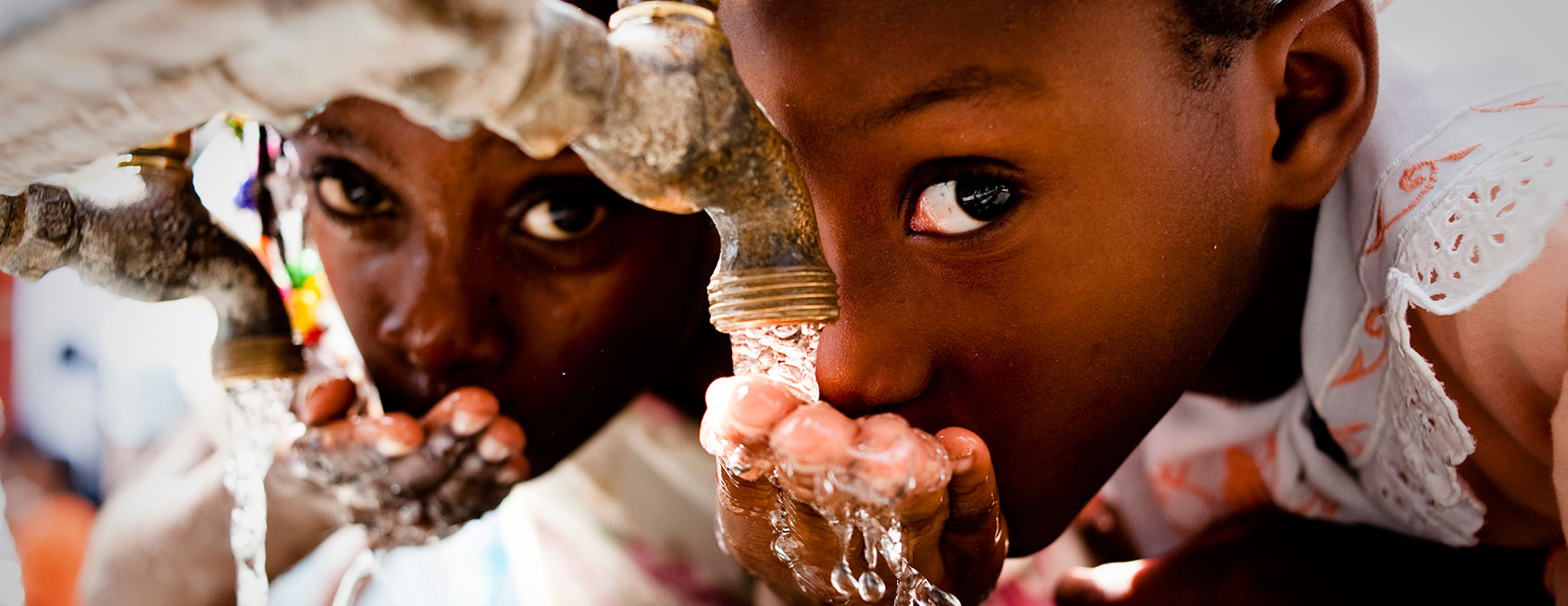 Haitian girls drinking water