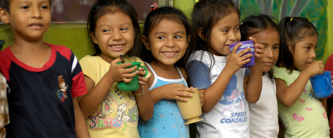 Children eating from mugs