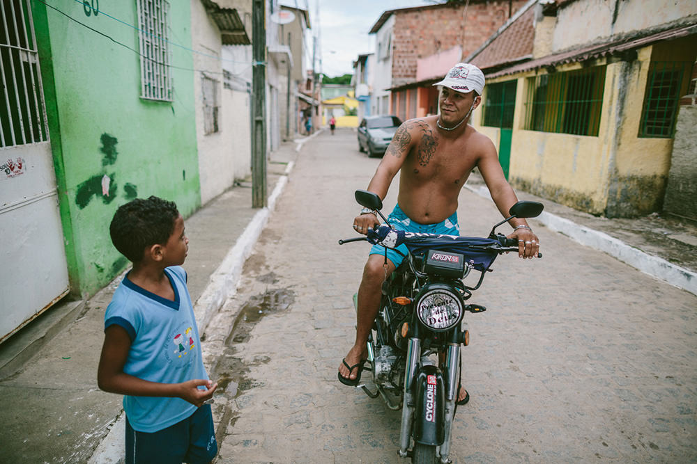 Emidio talking to a man outside his home