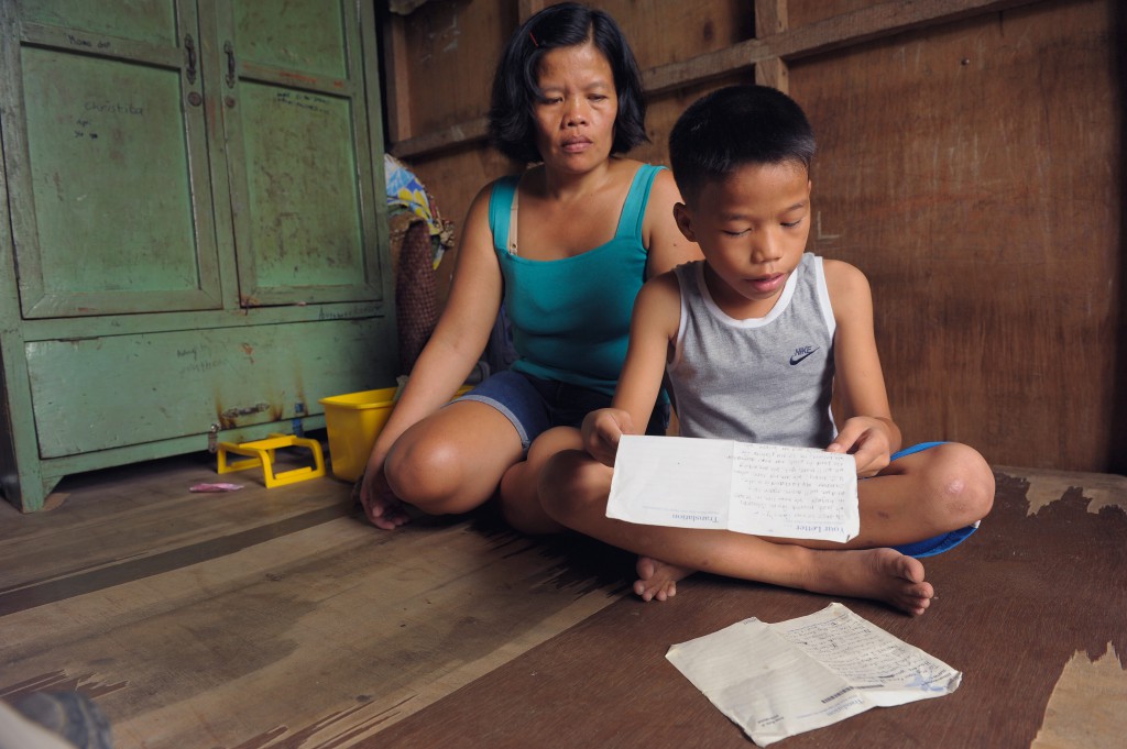 7-year-old Jose from the Philippines tucks his letters away in the family cabinet