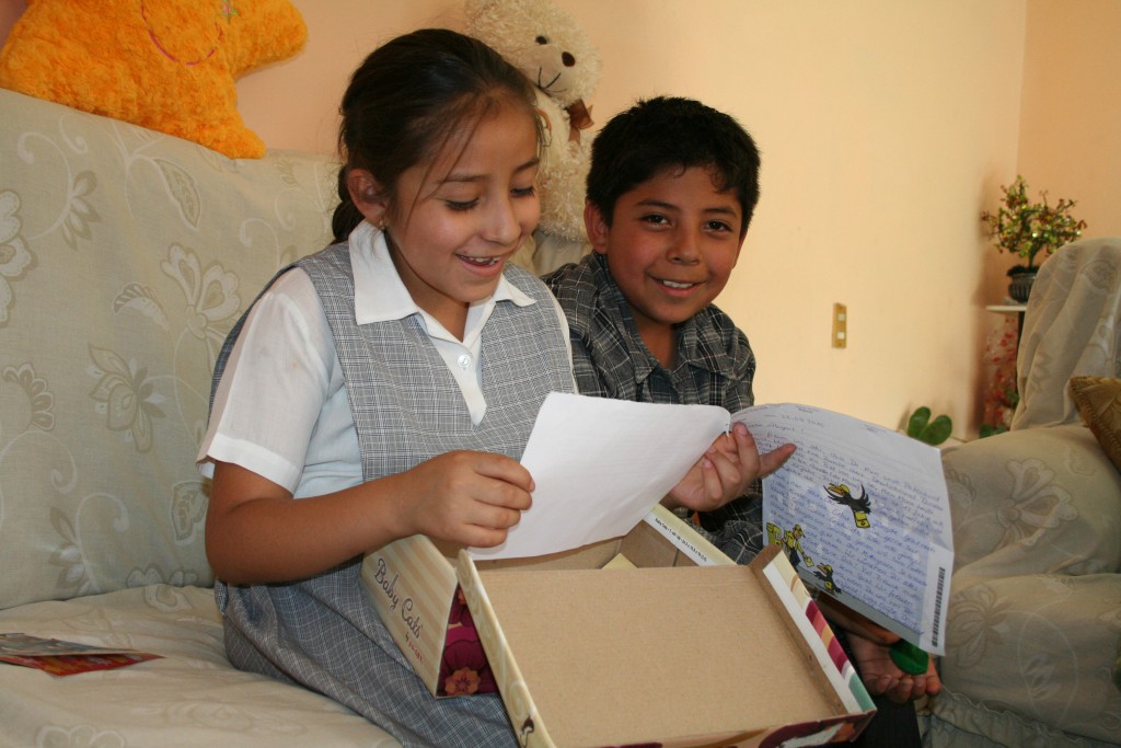 8-year-old Belinda from Mexico showing her letters to her brother