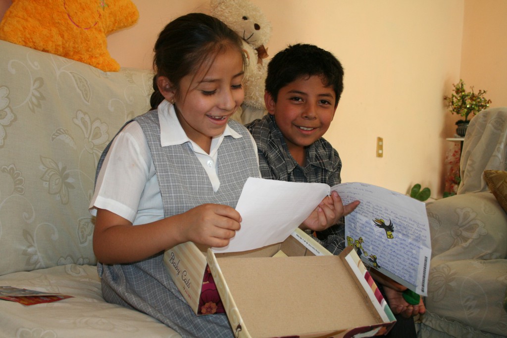 8-year-old Belinda from Mexico showing her letters to her brother