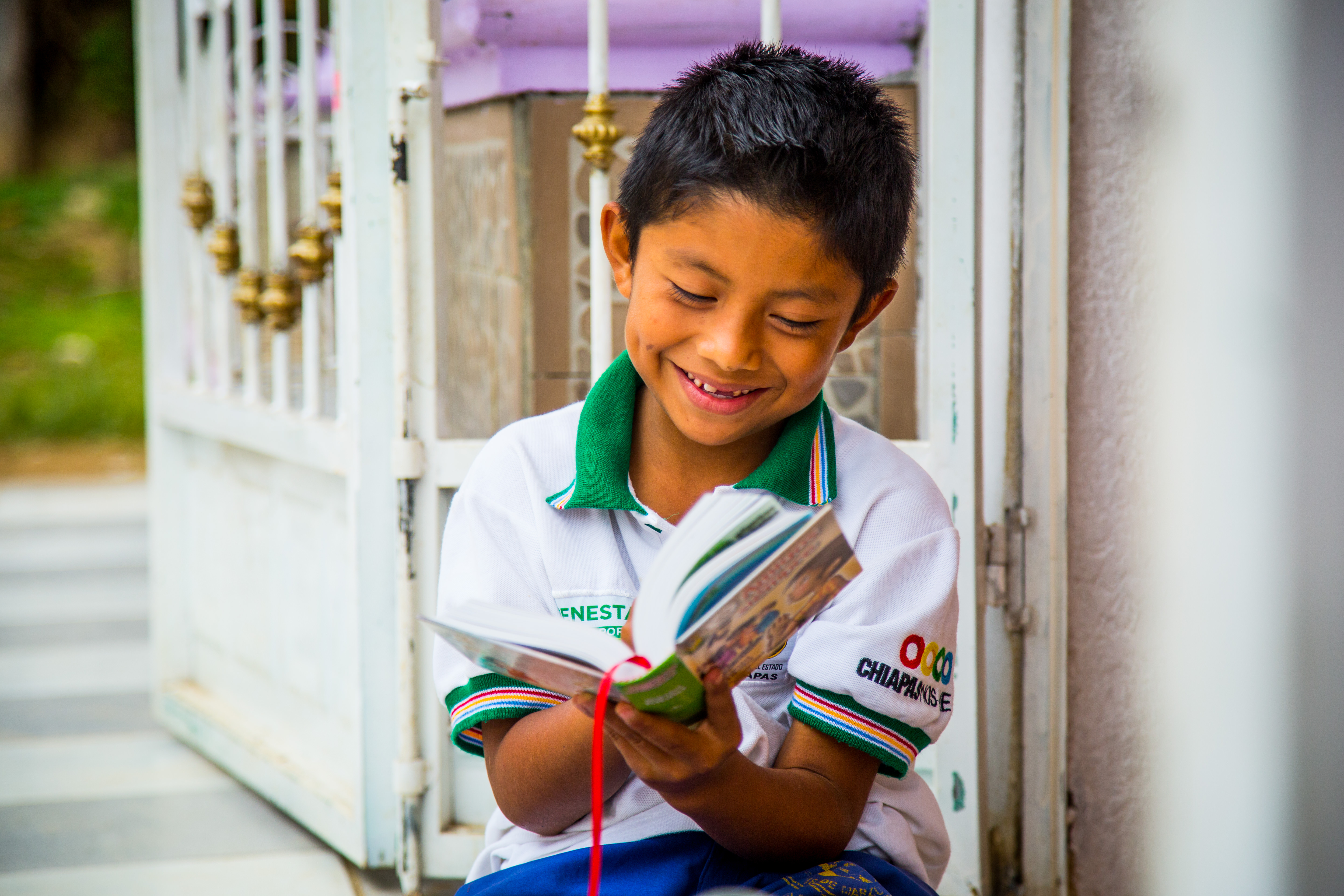 Mexican sponsored child pleased with his new Bible