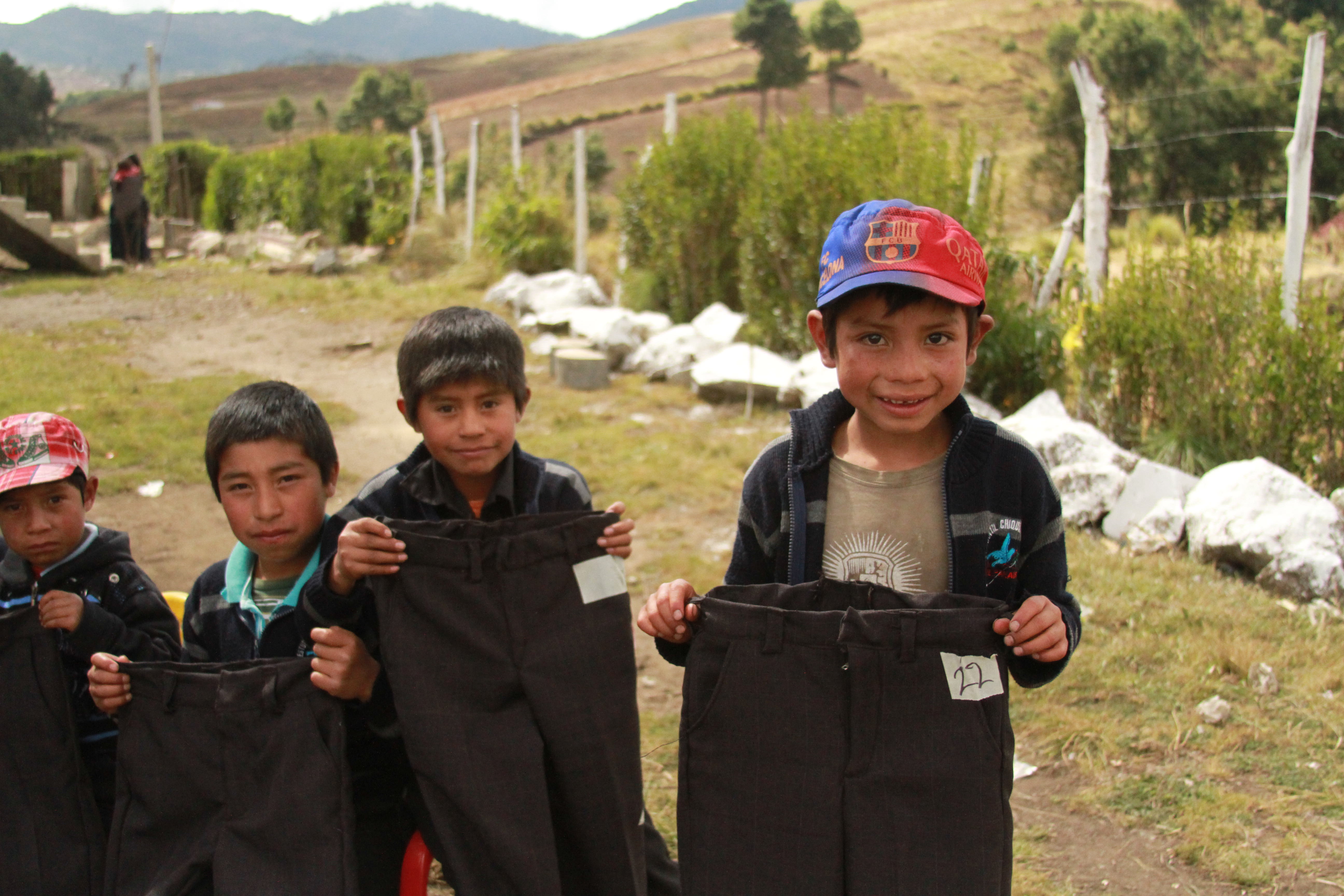 Guatemalan children with the clothes they received for Christmas