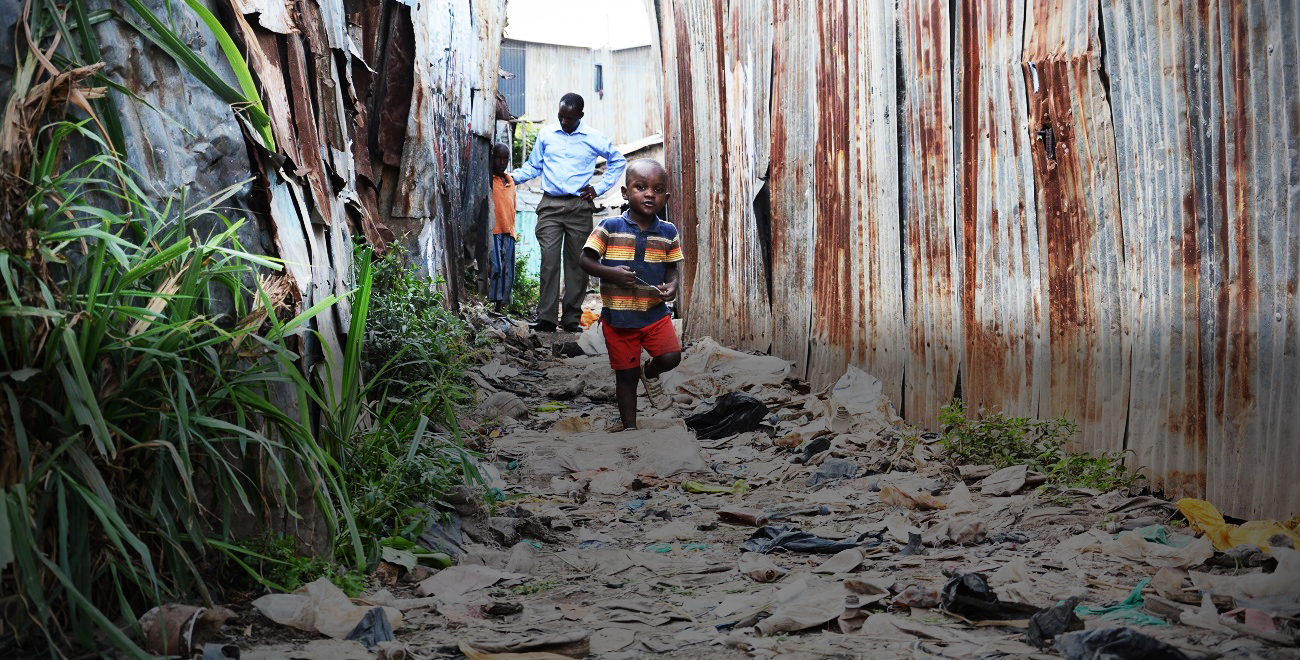 Child running through Kiambiu