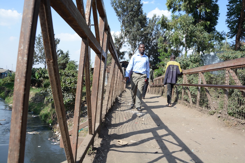 Walking over the bridge to Kiambiu slum