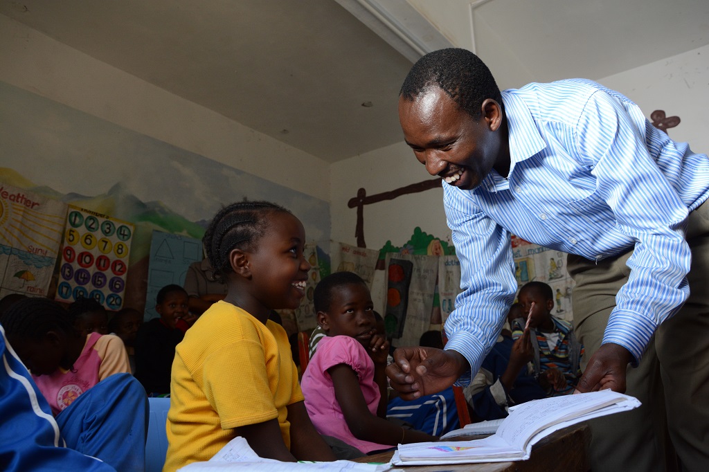 Bonnie giving children extra help with their reading and writing