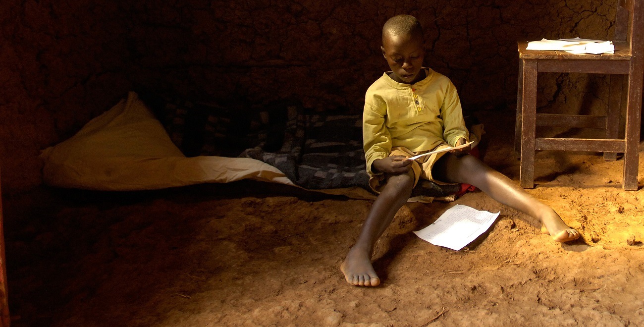 Rwandan boy reading letters