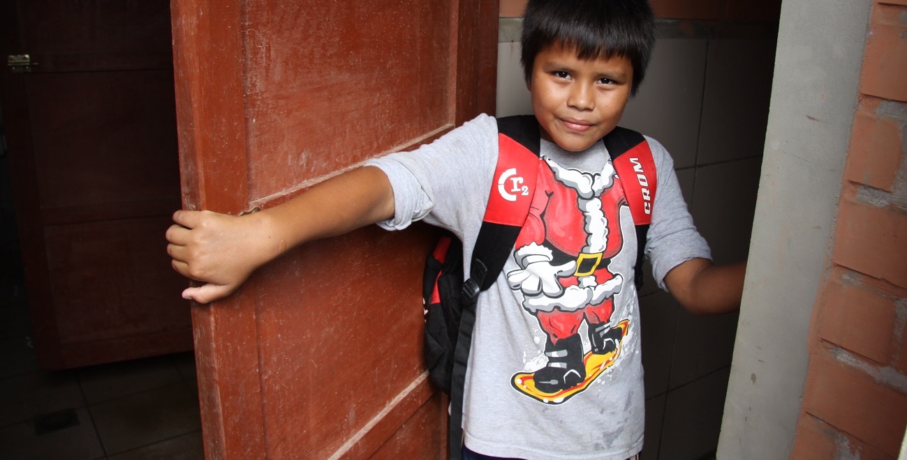 Boy outside Bolivian toilet