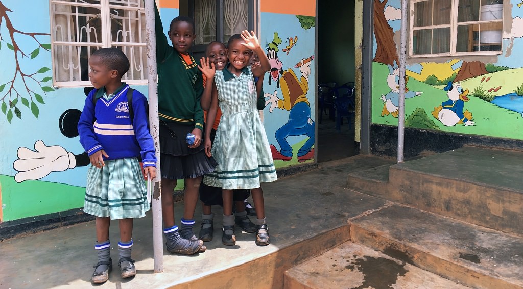 Ugandan children outside of a Compassion project