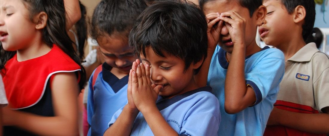 Children praying in El Salvador