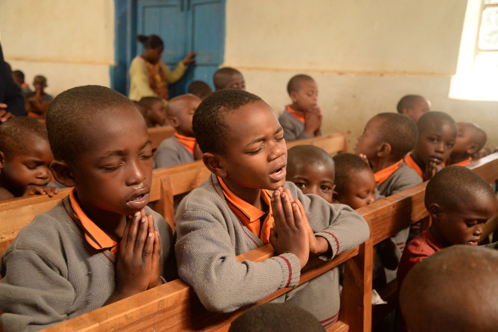 Children praying in Uganda