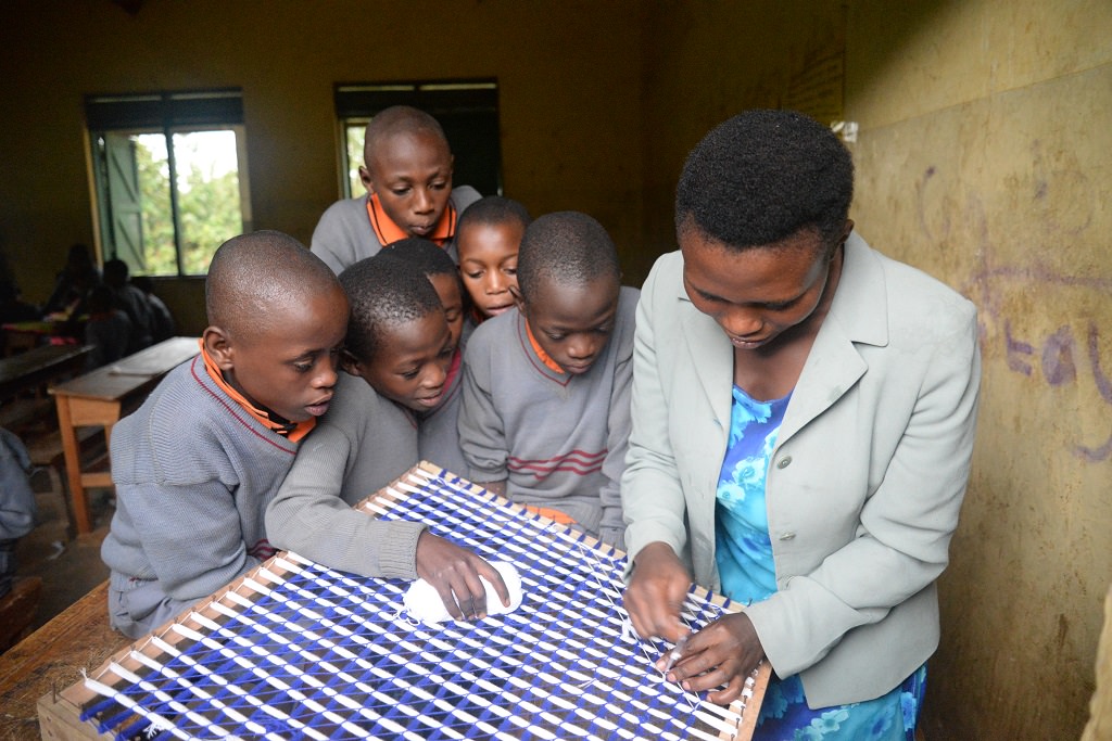 Learning weaving at a Compassion project in Uganda