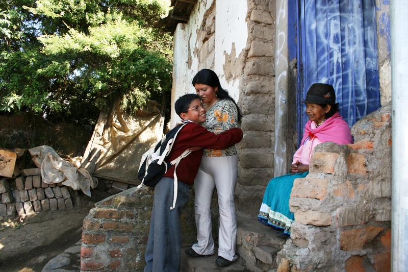 Bolivian sponsored child hugs his mother