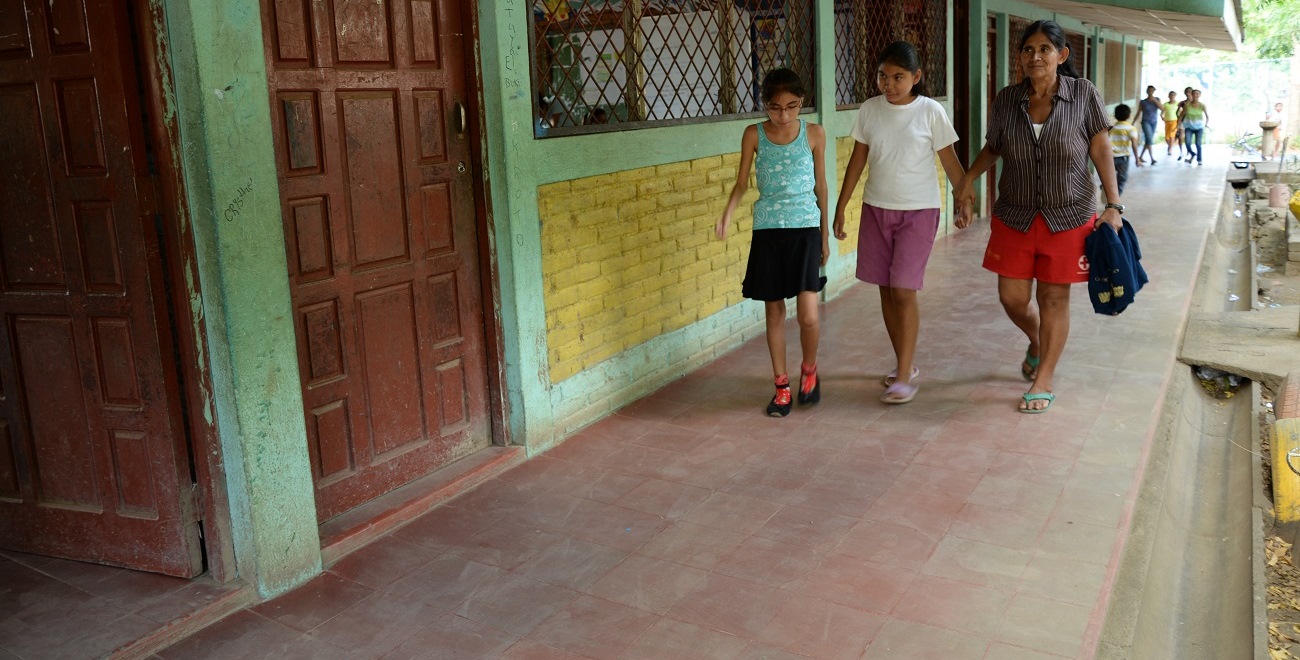 Nicaraguan mother walking children to school