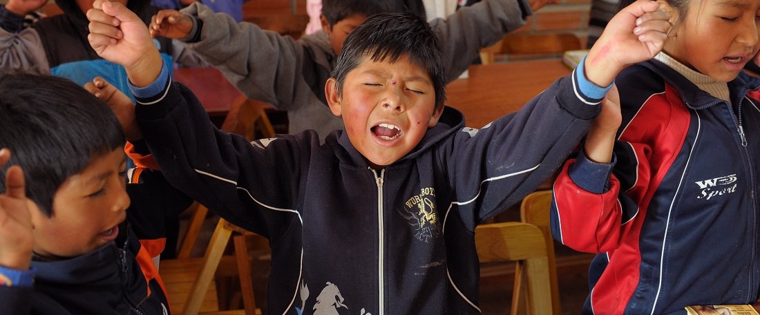 Bolivian boy worshipping God