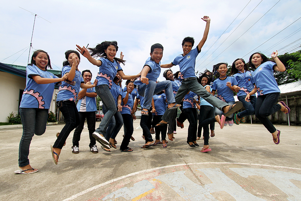 College students jump playfully on campus