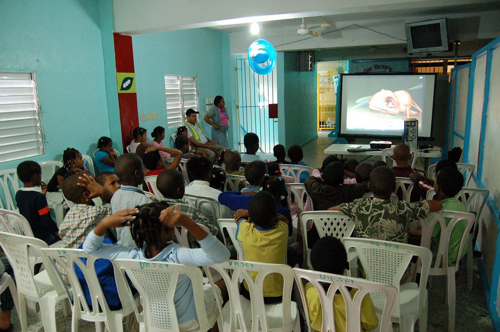 Compassion Dominican Republic children watching tv after a natural disaster