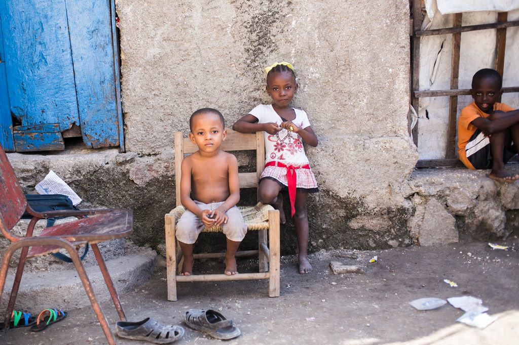 Haitian children sitting on chair