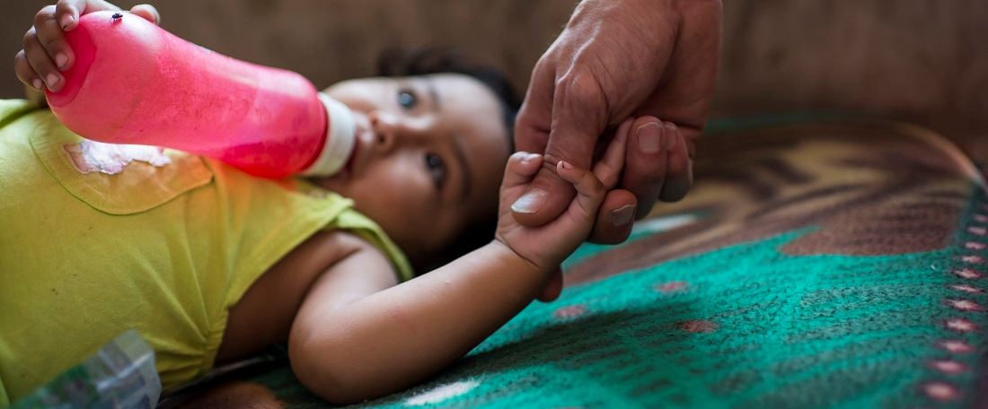 Holding Bolivian baby's hand