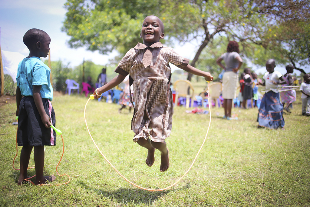 Young girl playing and skipping rope