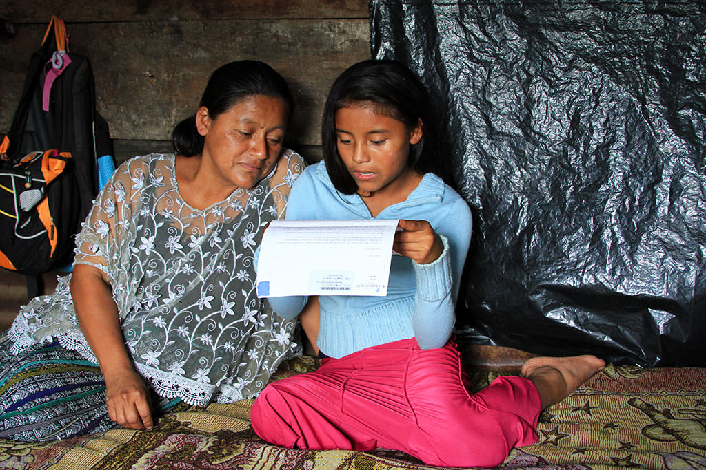 Mother and daughter reading sponsor letters