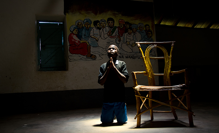 Boy praying at Lent