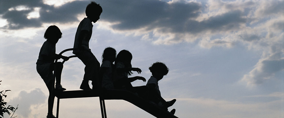 Guatemalan children playing on a slide