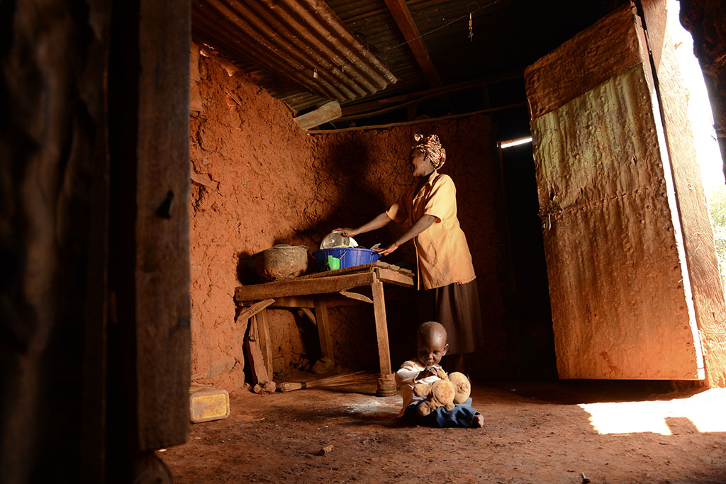 Kevin and his mum in their house in Kenya