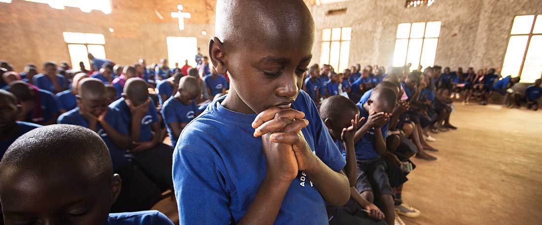 Boy praying in Rwanda