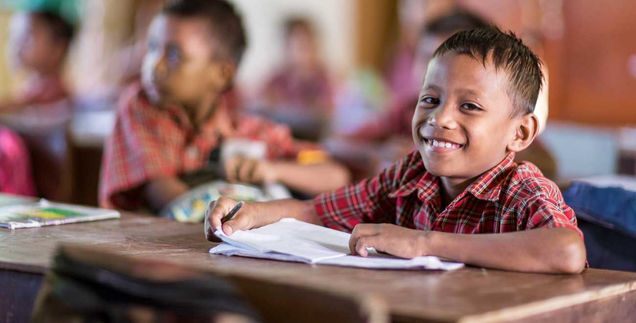 Indonesian boy sitting at desk