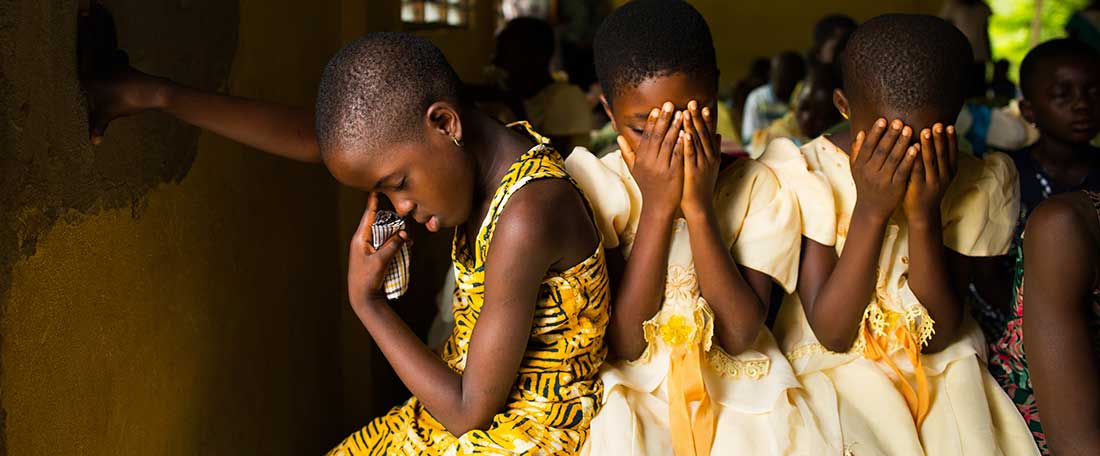 Girls praying in Ghana