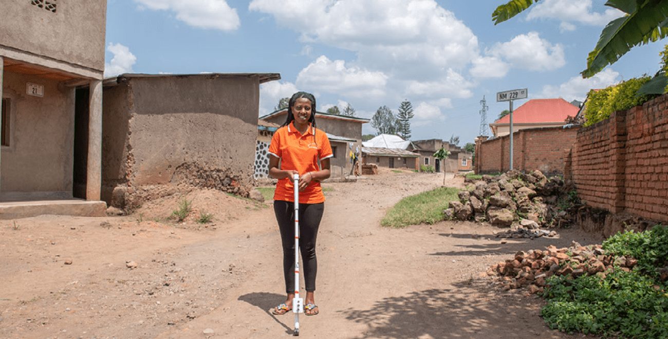 Yvette stands with her digital cane invention.