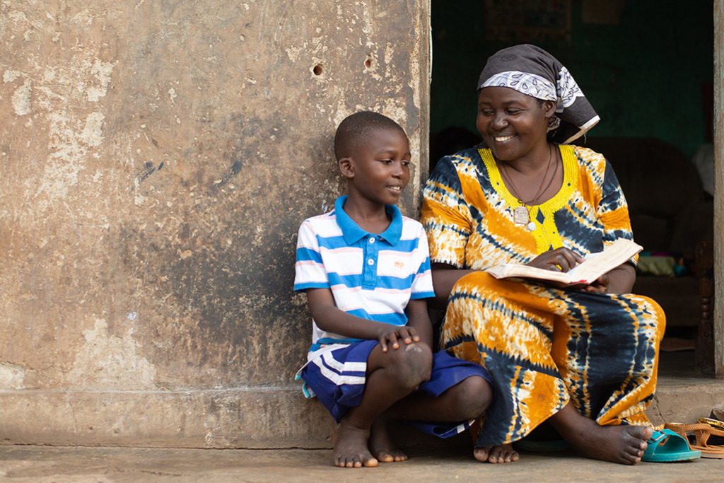 Stephen sits with his mum as they read the Bible together.